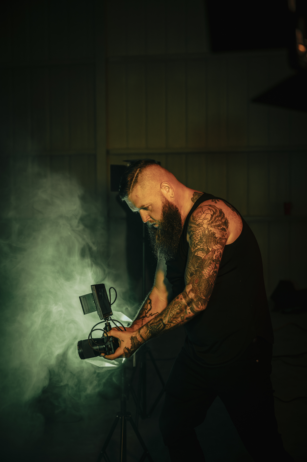 Justin Paul filming on set with dramatic lighting